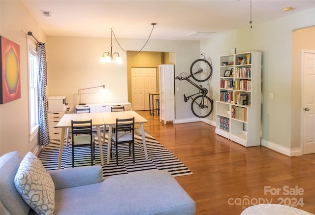 dining area featuring plenty of natural light, a chandelier, and hardwood / wood-style flooring