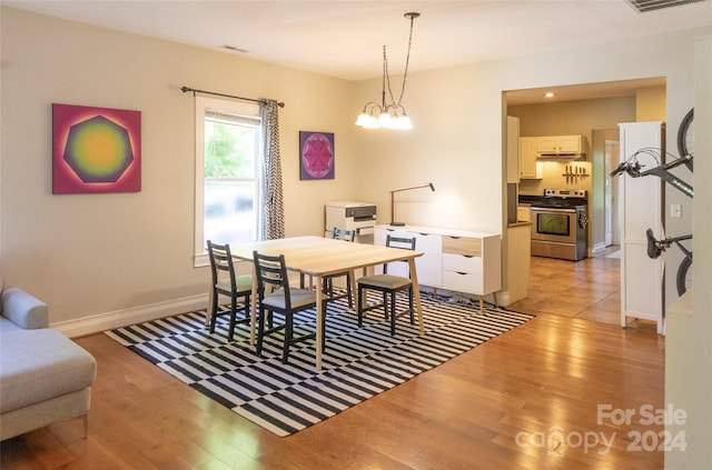 dining space featuring a chandelier and light hardwood / wood-style floors