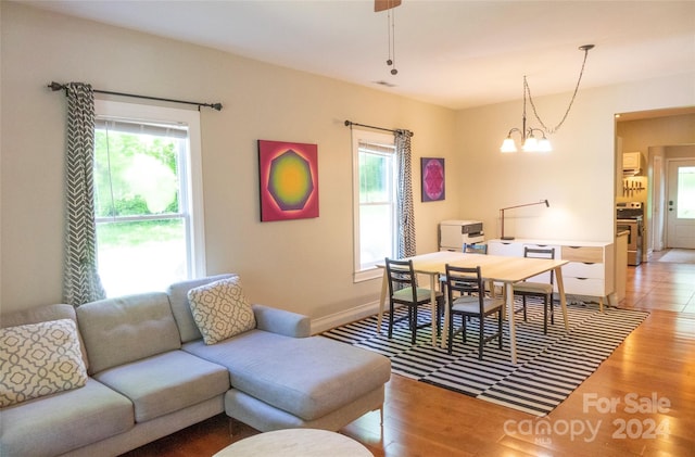 living room with a chandelier and hardwood / wood-style floors