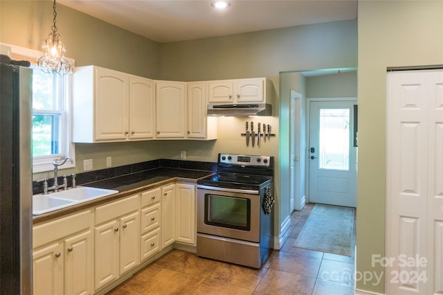 kitchen featuring pendant lighting, white cabinets, sink, appliances with stainless steel finishes, and a chandelier