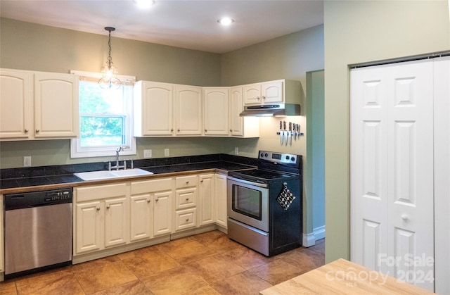 kitchen featuring sink, a chandelier, decorative light fixtures, white cabinets, and appliances with stainless steel finishes