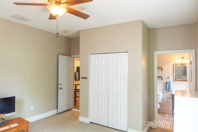 office space featuring light carpet and ceiling fan