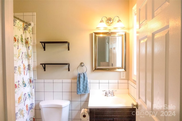 bathroom featuring a shower with curtain, vanity, toilet, and tile walls