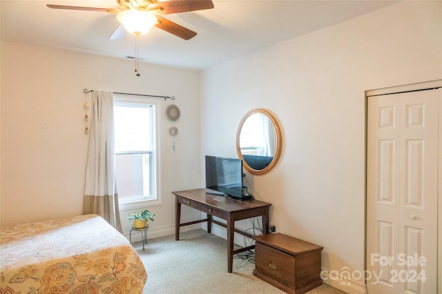 carpeted bedroom featuring ceiling fan, a closet, and multiple windows