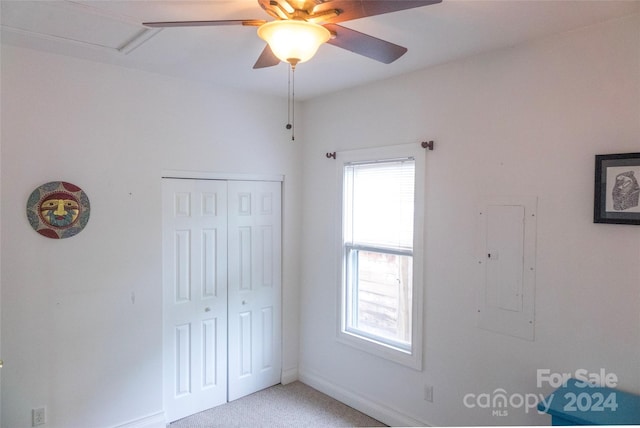 unfurnished bedroom featuring electric panel, ceiling fan, and a closet