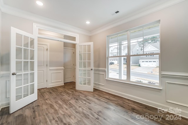 unfurnished room with french doors, crown molding, and hardwood / wood-style floors