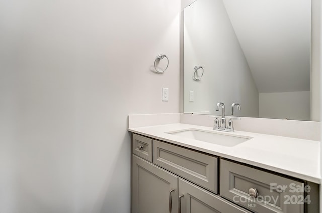 bathroom featuring vanity and vaulted ceiling