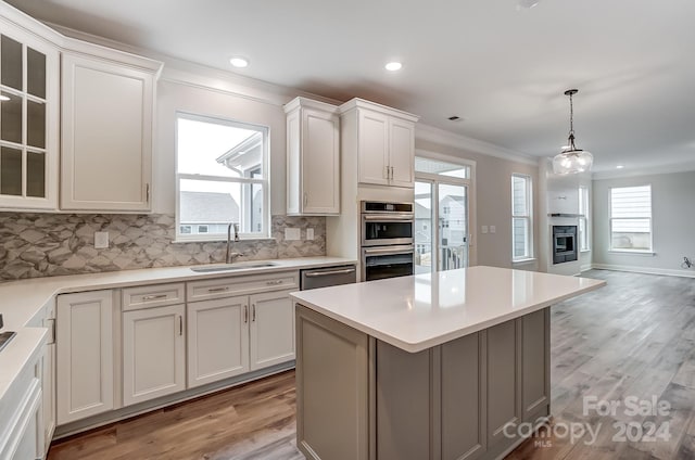 kitchen featuring plenty of natural light, sink, and light hardwood / wood-style flooring