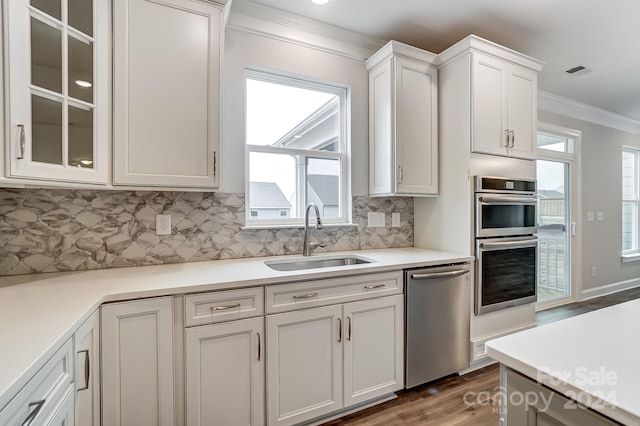 kitchen with white cabinetry, sink, appliances with stainless steel finishes, and tasteful backsplash