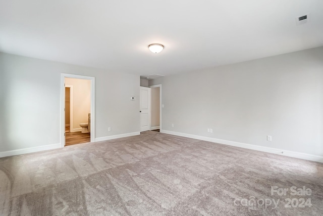 spare room featuring light colored carpet