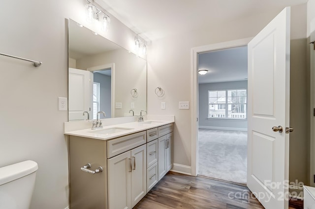 bathroom featuring hardwood / wood-style floors, vanity, and toilet