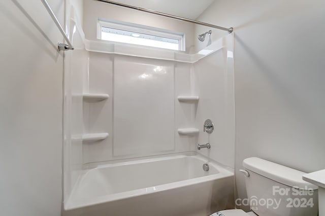 bathroom featuring shower / bathtub combination and toilet