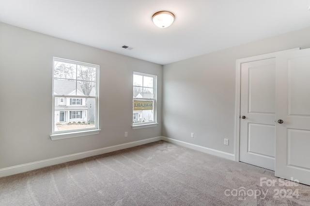 unfurnished bedroom with light carpet