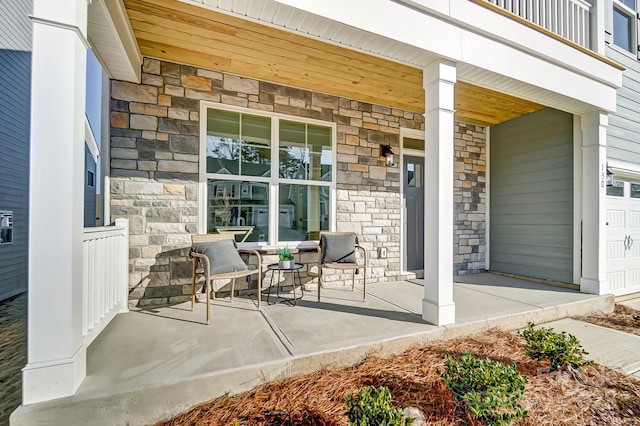 view of patio / terrace with a balcony and a porch