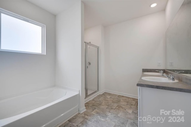 bathroom with tile floors, plus walk in shower, and oversized vanity