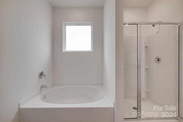 bathroom featuring plus walk in shower