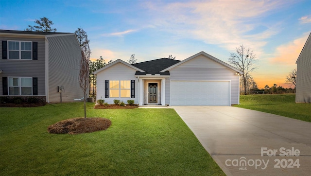 single story home with a garage and a lawn