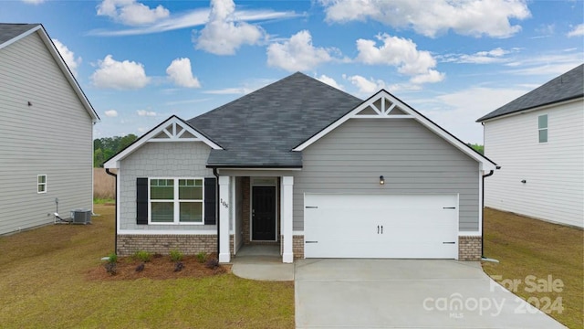 craftsman inspired home with central AC, a garage, and a front yard