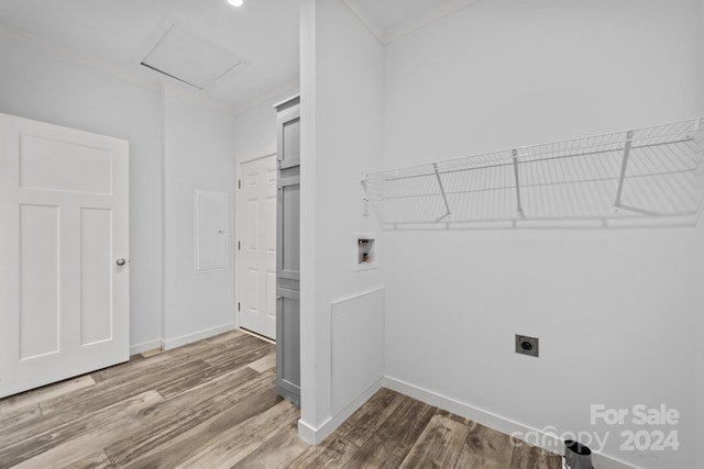 laundry room with hookup for a washing machine, electric dryer hookup, hardwood / wood-style flooring, and crown molding