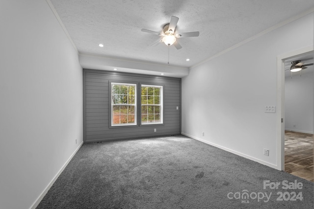 empty room with a textured ceiling, crown molding, and ceiling fan