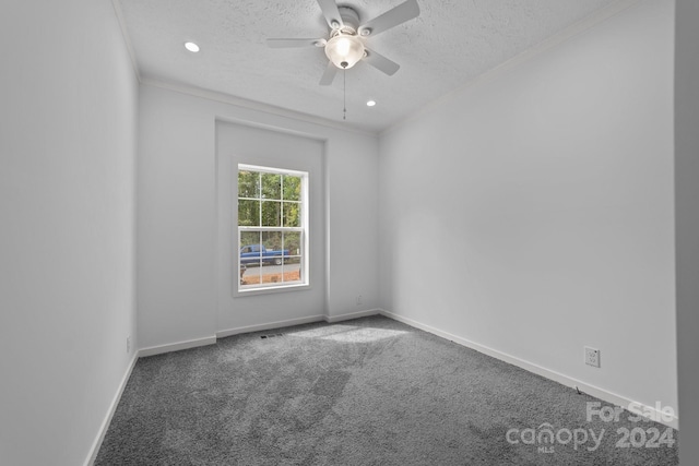 spare room with ceiling fan, crown molding, carpet flooring, and a textured ceiling