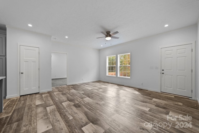 spare room featuring ceiling fan, a textured ceiling, and dark hardwood / wood-style flooring