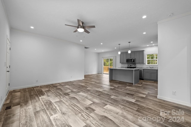 unfurnished living room with light hardwood / wood-style floors and ceiling fan