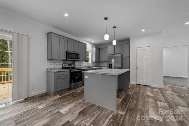 kitchen with gray cabinets, stainless steel appliances, and a center island