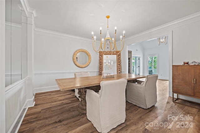 dining area with dark hardwood / wood-style flooring, a notable chandelier, and ornamental molding