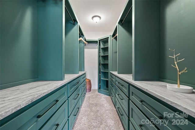 walk in closet featuring light colored carpet