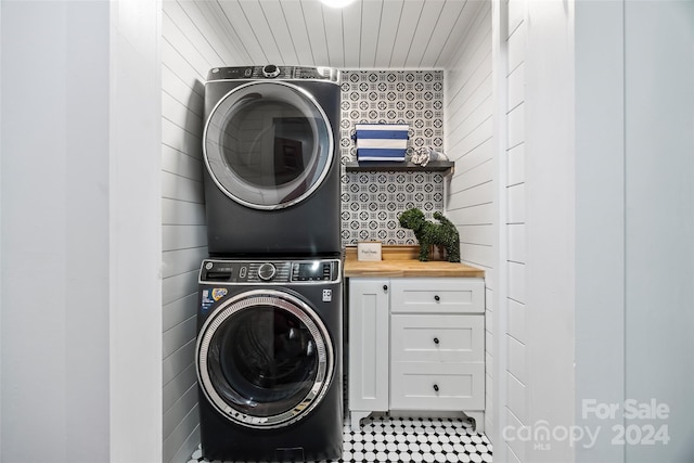 laundry area featuring stacked washer / drying machine