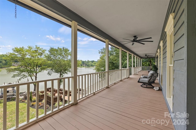 wooden terrace featuring a water view and ceiling fan