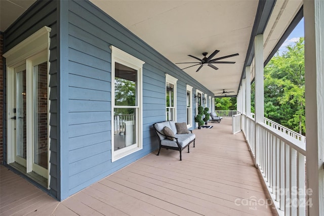 wooden terrace featuring ceiling fan