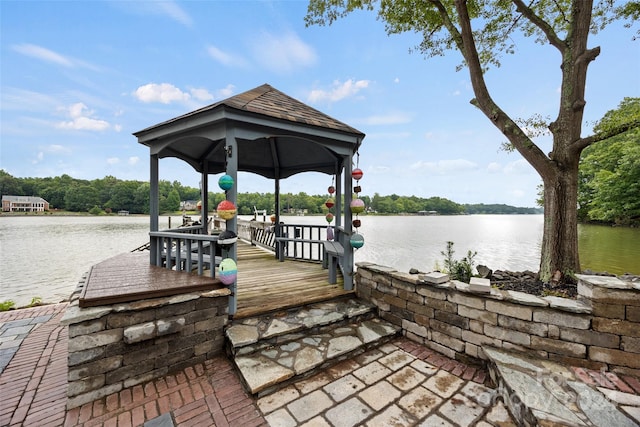 view of dock with a gazebo and a water view