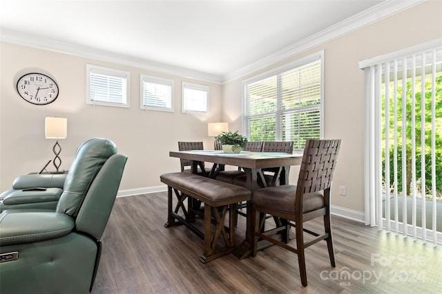 dining room with dark hardwood / wood-style floors, plenty of natural light, and crown molding