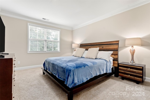 bedroom with crown molding and light colored carpet