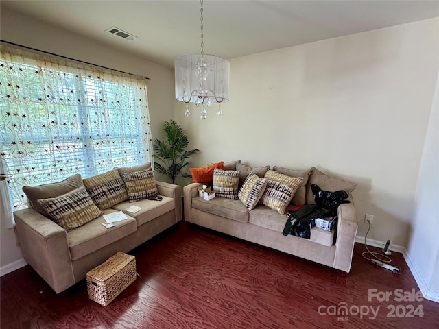 living room featuring dark hardwood / wood-style floors and an inviting chandelier