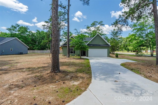 view of front of property featuring a garage and a front yard