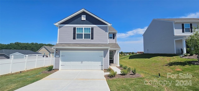 view of front of home with a garage, a front yard, concrete driveway, and fence