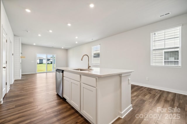 kitchen featuring white cabinetry, sink, dishwasher, plenty of natural light, and a center island with sink