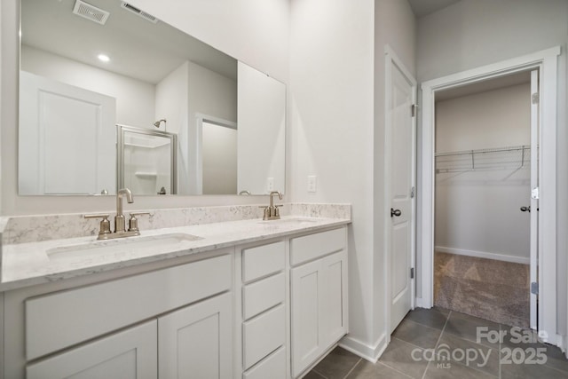 bathroom featuring tile patterned floors, vanity, and an enclosed shower