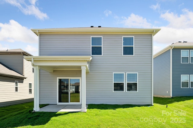 rear view of property with a yard and a patio