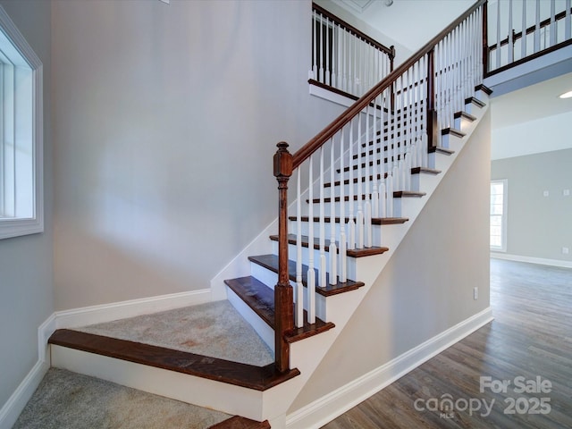 stairway with hardwood / wood-style flooring