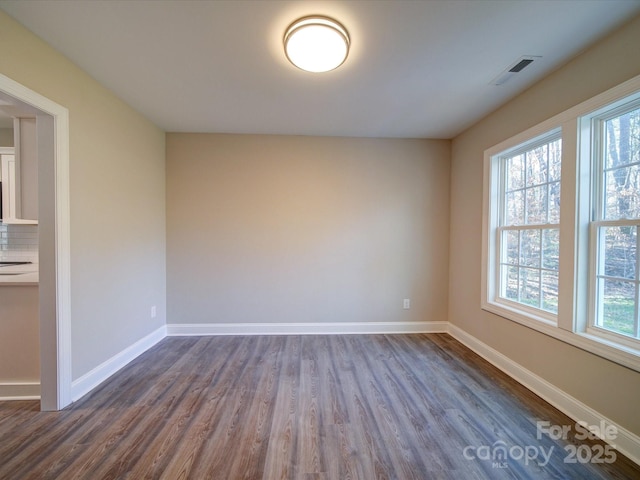 spare room with dark hardwood / wood-style flooring