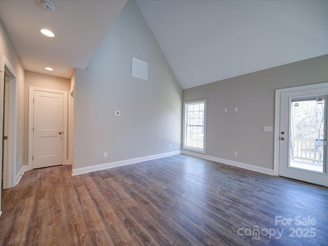 unfurnished living room with high vaulted ceiling and dark hardwood / wood-style floors