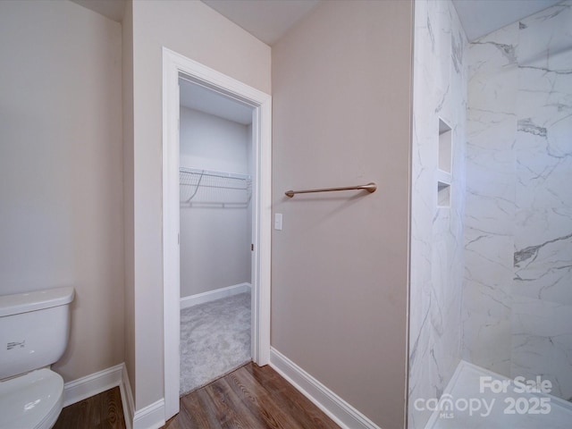 bathroom with walk in shower, hardwood / wood-style floors, and toilet