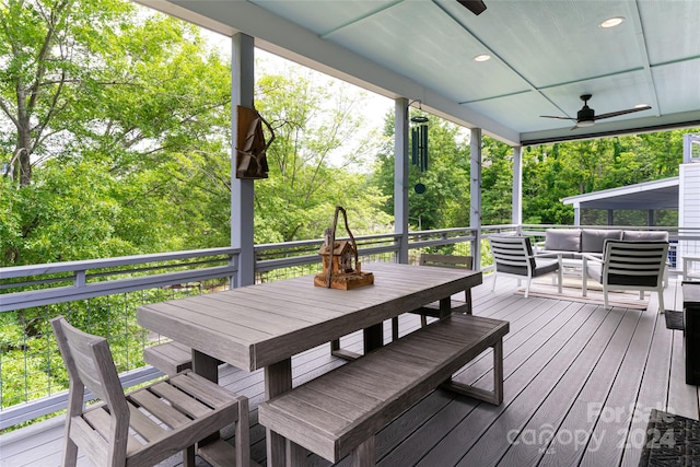 wooden deck featuring outdoor lounge area and ceiling fan