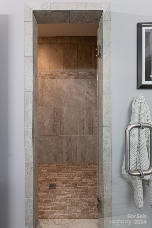 bathroom featuring a shower with shower door