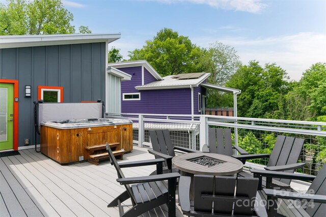 wooden deck featuring a fire pit