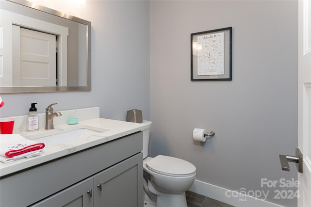 bathroom featuring toilet, tile floors, and large vanity